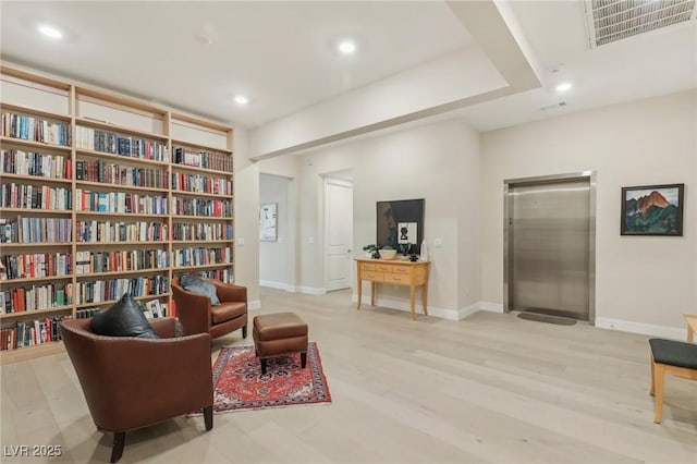 sitting room with visible vents, recessed lighting, baseboards, and wood finished floors