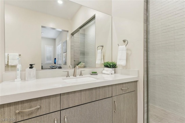 full bathroom with vanity and a shower stall