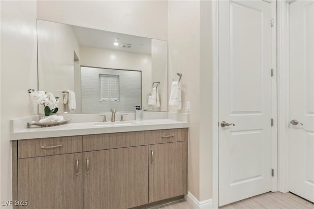 bathroom with baseboards and vanity