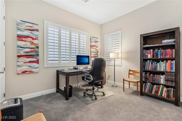 carpeted office featuring baseboards