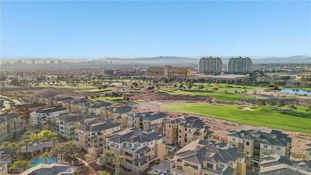 aerial view featuring a view of city, golf course view, and a water view