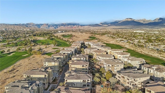 drone / aerial view featuring view of golf course, a mountain view, and a residential view