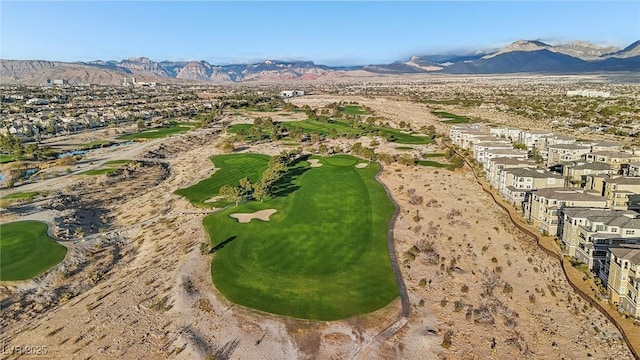 birds eye view of property with golf course view and a mountain view