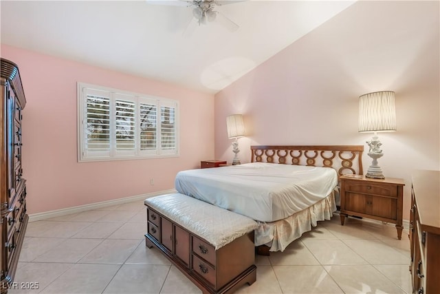 bedroom with baseboards, lofted ceiling, light tile patterned flooring, and a ceiling fan