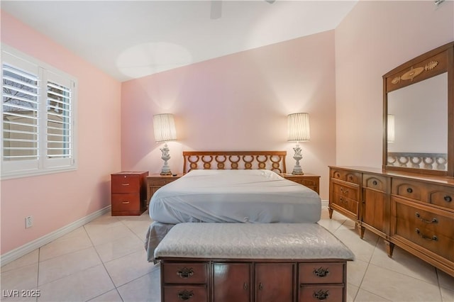 bedroom with light tile patterned flooring and baseboards