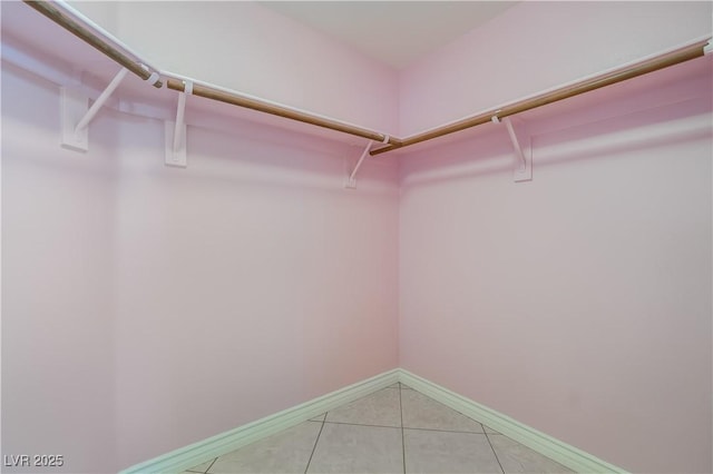 walk in closet featuring light tile patterned flooring