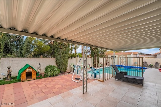 view of swimming pool with a fenced backyard, a fenced in pool, and a patio