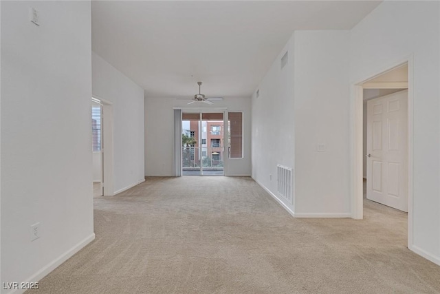 unfurnished room featuring carpet flooring, baseboards, visible vents, and ceiling fan