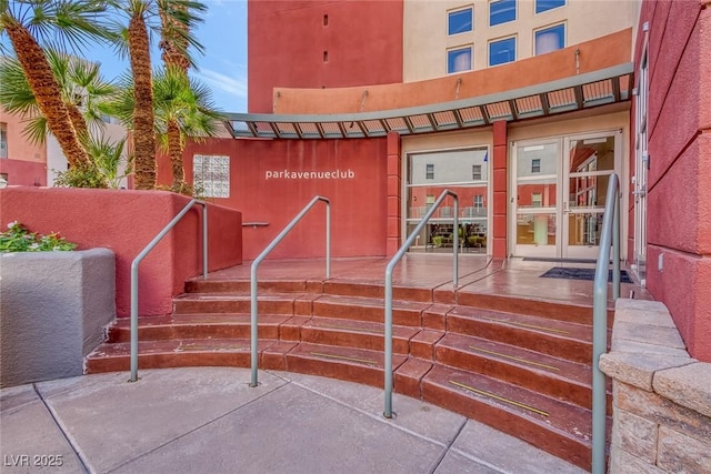 doorway to property featuring stucco siding