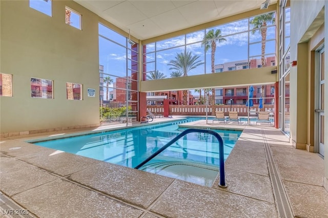 community pool with a patio and fence