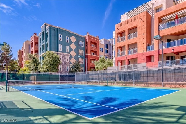 view of sport court featuring fence