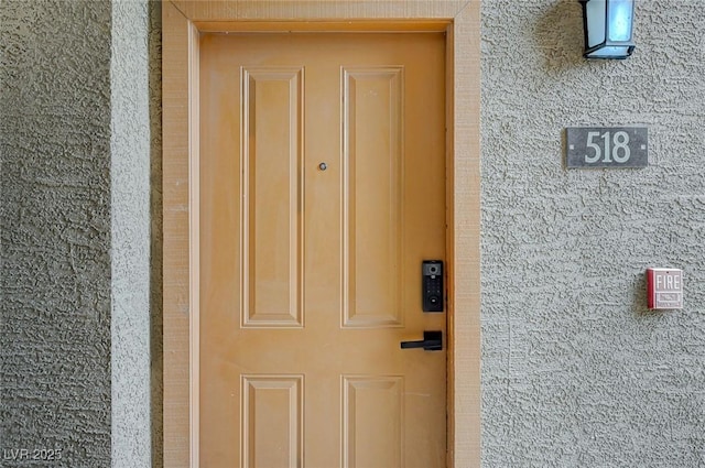 doorway to property featuring brick siding