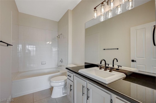 full bath featuring vanity, toilet, washtub / shower combination, and tile patterned flooring