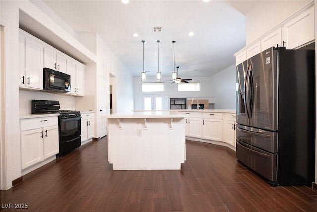 kitchen with black appliances, light countertops, white cabinetry, a ceiling fan, and dark wood-style flooring