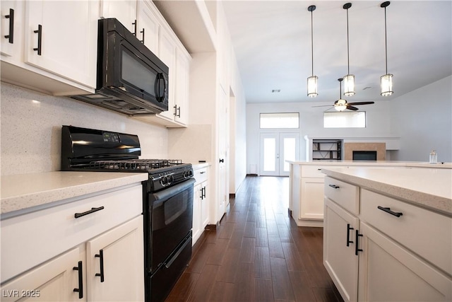 kitchen featuring backsplash, ceiling fan, pendant lighting, black appliances, and dark wood-style flooring