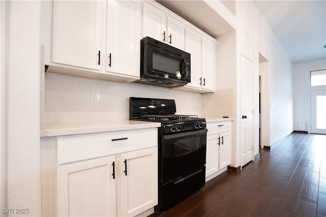 kitchen with black appliances, dark wood finished floors, white cabinetry, light countertops, and baseboards