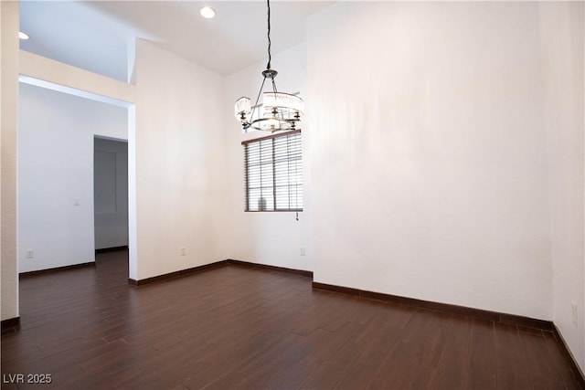 unfurnished room featuring dark wood finished floors, recessed lighting, baseboards, and a chandelier