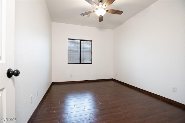 spare room featuring ceiling fan, visible vents, baseboards, and dark wood-style floors