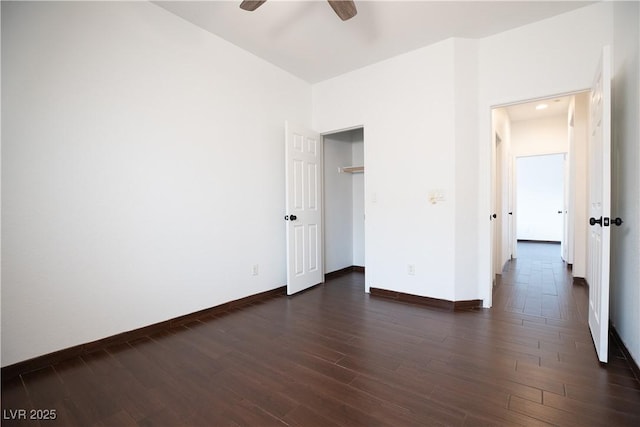 unfurnished bedroom featuring baseboards, dark wood finished floors, and a ceiling fan