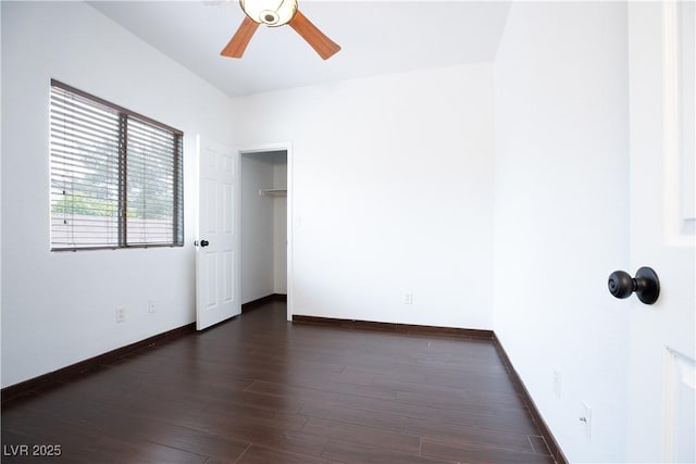 unfurnished bedroom with ceiling fan, baseboards, and dark wood-style flooring