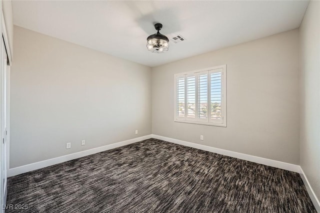 unfurnished room with visible vents and baseboards