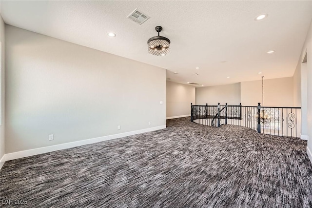 unfurnished room with visible vents, recessed lighting, carpet flooring, and baseboards