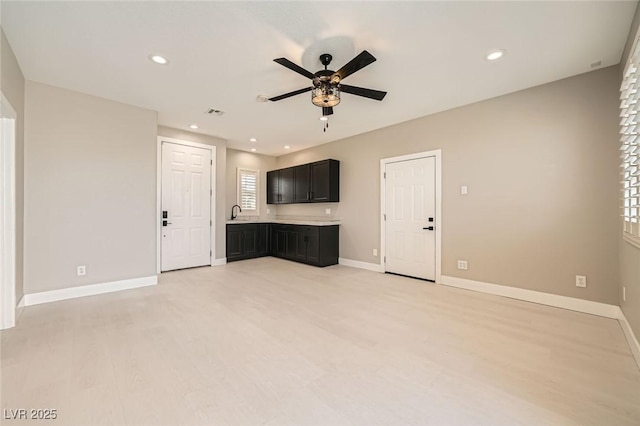 unfurnished living room featuring recessed lighting, baseboards, and a ceiling fan