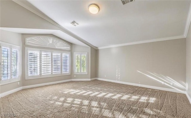 empty room with visible vents, carpet floors, baseboards, and vaulted ceiling