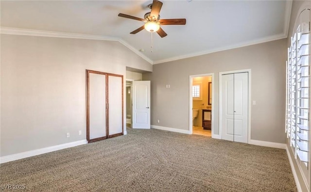 unfurnished bedroom featuring vaulted ceiling, carpet flooring, baseboards, and ornamental molding