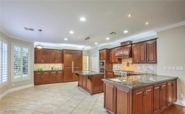 kitchen with visible vents, a breakfast bar, ornamental molding, custom range hood, and a sink