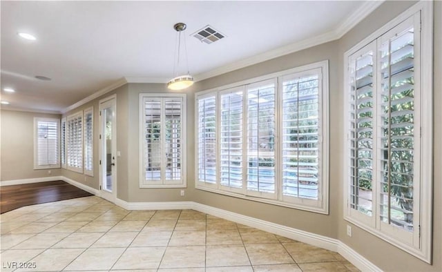 unfurnished dining area with light tile patterned floors, visible vents, baseboards, and ornamental molding