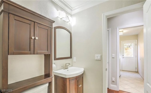 bathroom featuring tile patterned floors, vanity, and crown molding