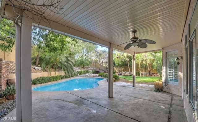 outdoor pool with a patio and a ceiling fan