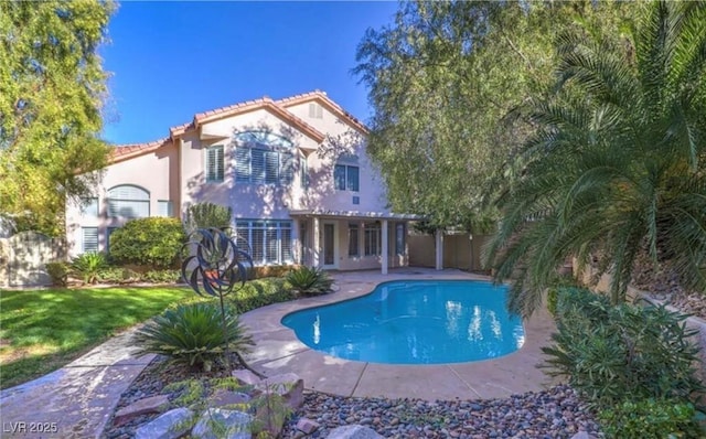 outdoor pool featuring a patio and fence