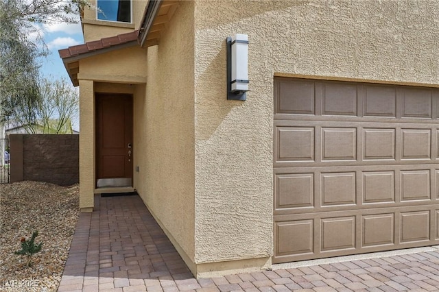 view of exterior entry featuring stucco siding