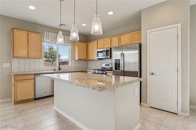 kitchen with visible vents, backsplash, appliances with stainless steel finishes, and light brown cabinets