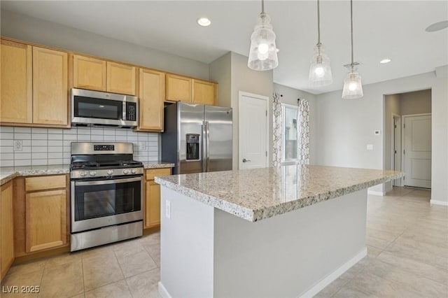 kitchen featuring a kitchen island, light tile patterned flooring, stainless steel appliances, pendant lighting, and backsplash