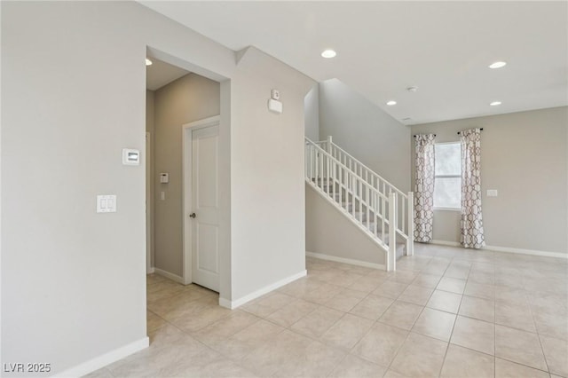 spare room featuring stairs, light tile patterned floors, recessed lighting, and baseboards