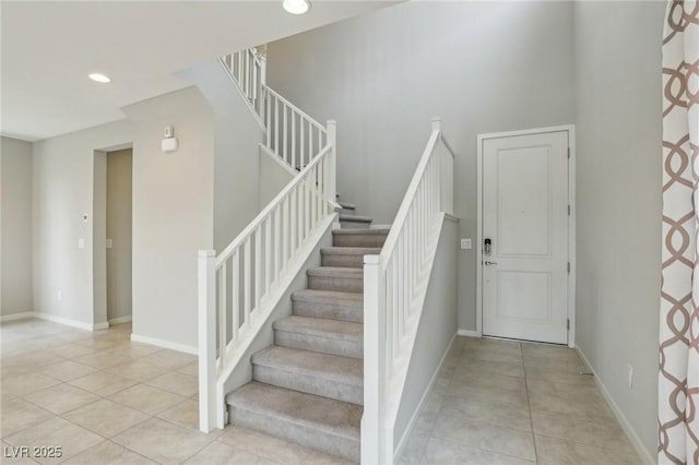 staircase with tile patterned flooring, recessed lighting, and baseboards