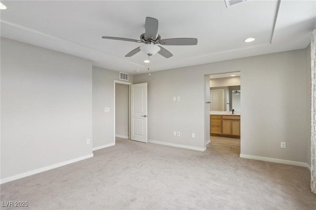 unfurnished bedroom with visible vents, recessed lighting, connected bathroom, baseboards, and light colored carpet