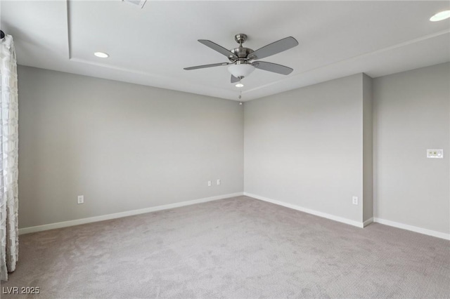 carpeted spare room with recessed lighting, a ceiling fan, and baseboards