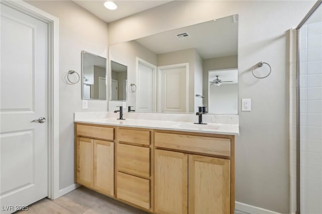 bathroom featuring double vanity, visible vents, a ceiling fan, and a sink