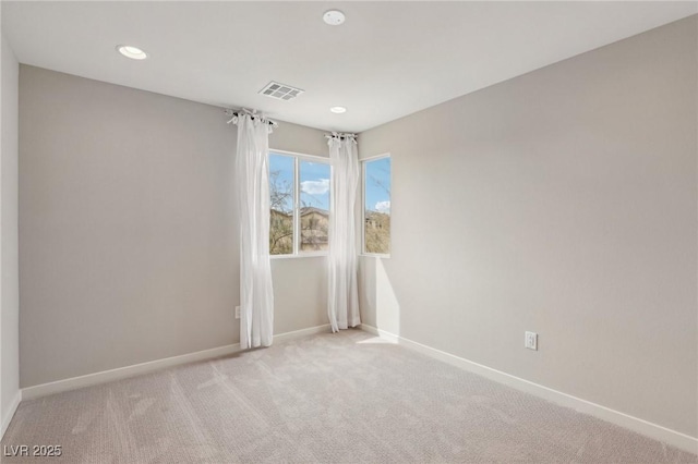 empty room featuring recessed lighting, visible vents, baseboards, and light colored carpet