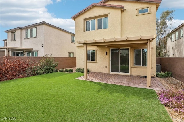 rear view of house featuring a patio, central AC unit, a fenced backyard, stucco siding, and a lawn