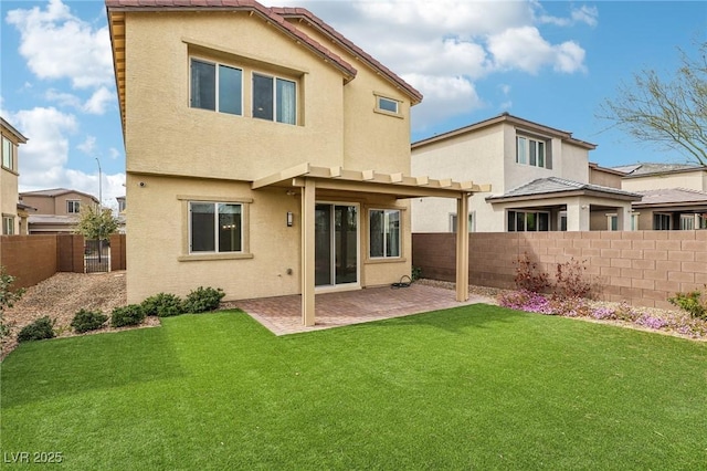 back of property featuring stucco siding, a lawn, a fenced backyard, and a patio area