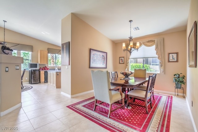 dining room featuring an inviting chandelier, plenty of natural light, visible vents, and light tile patterned floors