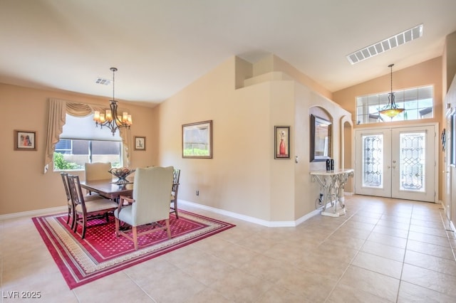 dining room featuring vaulted ceiling, a notable chandelier, french doors, and visible vents