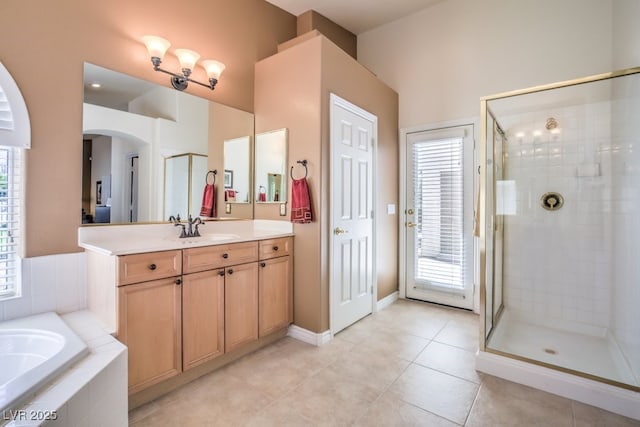 bathroom featuring tile patterned flooring, a shower stall, vanity, and a bath