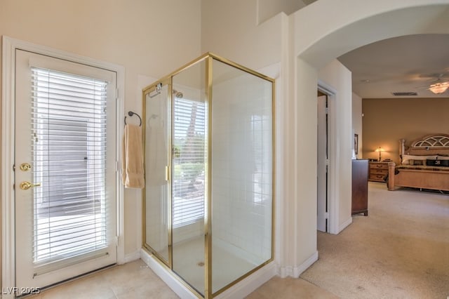 bathroom with tile patterned flooring, a shower stall, a ceiling fan, and visible vents