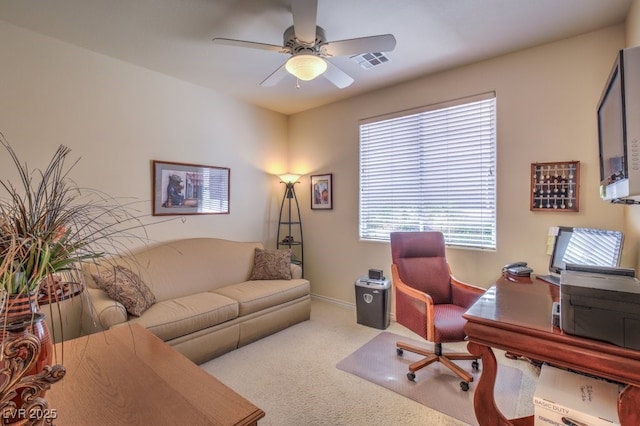 carpeted office with visible vents, baseboards, and ceiling fan